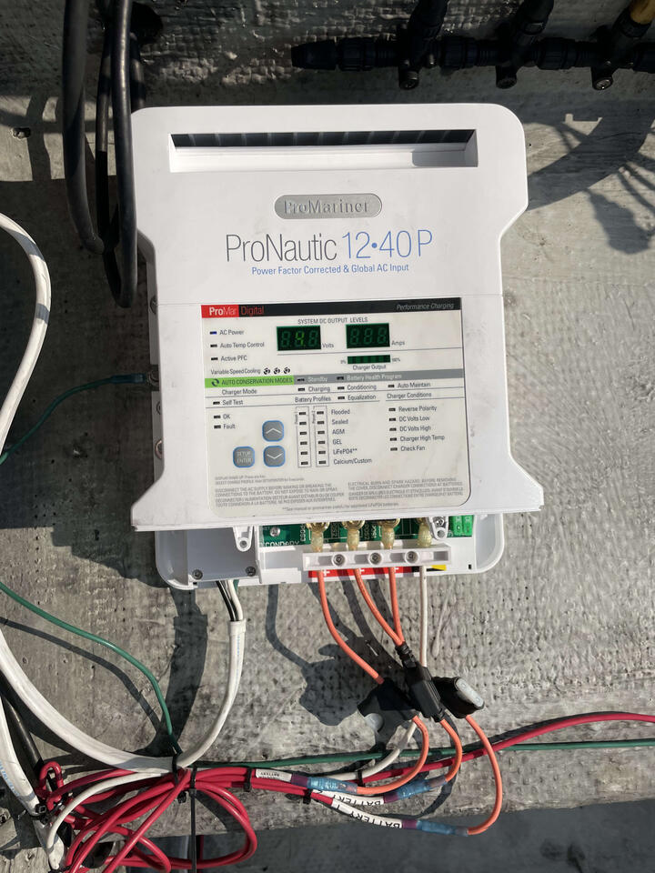 Inline fuses, waterproof crimp connections, water proof butt splice, labeled heatshrink. Male 110v port drilled, mounted and wired. Unit grounded to chassis per ABYC standard